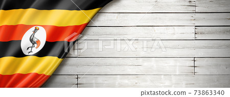 Uganda flag on old white wall banner Uganda flag on old white wall banner 73863340