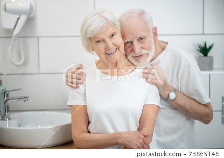 Elderly couple in the bathroom looking happy and smiling Elderly couple in the bathroom looking happy and smiling 73865148