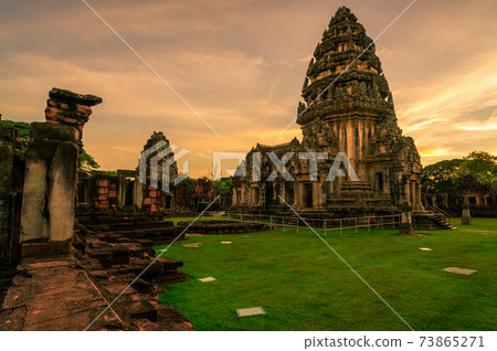 Landscape of Phimai Historical Park with sunset sky. Landmark of Nakhon Ratchasima, Thailand. Travel destinations. Historic site is ancient. Ancient building. Khmer temple classical architecture. 73865271