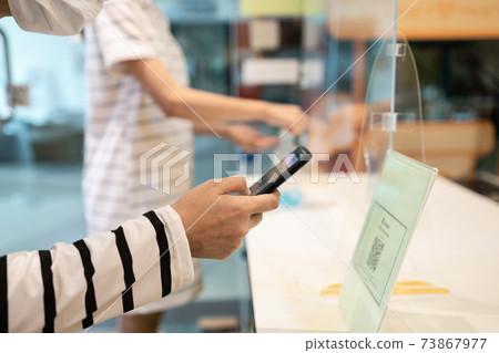 People wear face mask using the phone to scan QR code payment or register before entering and exiting in stores at the shopping mall,check in,check out,service during its reopening after Lockdown 73867977