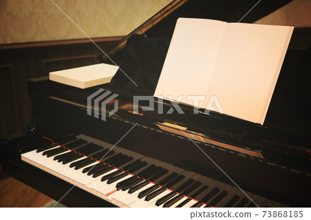 Close up of Piano keys with blank music sheet, toned image processed with filtered vintage effect. Close up of Piano keys with blank music sheet, toned image processed with filtered vintage effect. 73868185