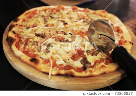 Delicious summer appetizer: Homemade pizza with mushroom and soft cheese. 73868837