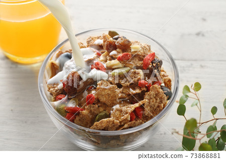 Breakfast cereals and flakes pouring milk 73868881