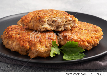 Buckwheat cutlets with cheese and parsley on a plate. Healthy diet food 73869333