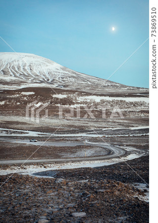 Road to Langjokull glacier in Iceland during winter, car driving in the background 73869510