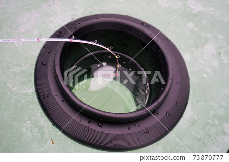 Smelt fishing on ice 73870777