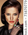 Fashion portrait in warm colors. Studio shooting. 73870779