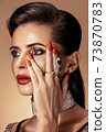 Fashion portrait in warm colors. Studio shooting. 73870783