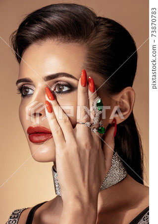Fashion portrait in warm colors. Studio shooting. Fashion portrait in warm colors. Studio shooting. 73870783