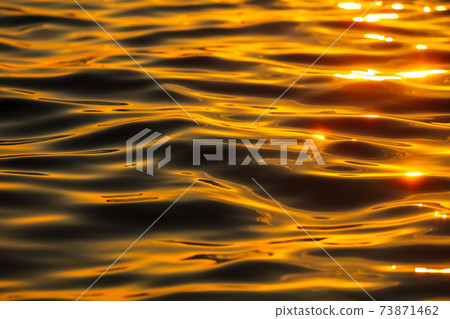 Smooth water in the sea in the rays of sunset Smooth water in the sea in the rays of sunset 73871462
