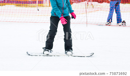 A guy is riding a snowboard from a mountain in winter A guy is riding a snowboard from a mountain in winter 73871692