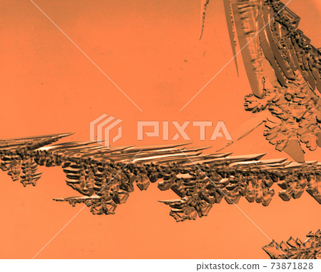 Snow and ice on red glass as background 73871828