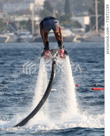 A man on a water attraction at sea 73872199