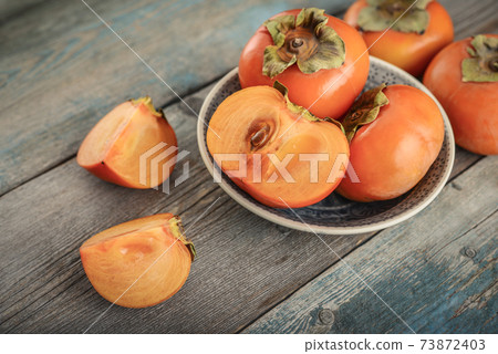 Fresh organic ripe Persimmon fruits 73872403