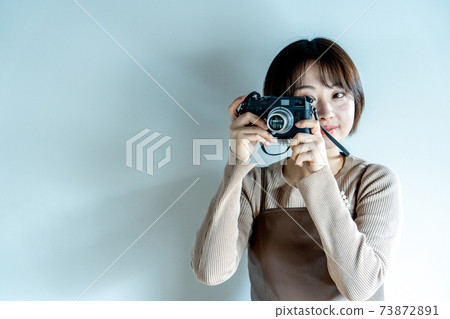 A woman taking a picture with a camera 73872891