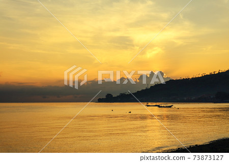 Views of the beach and the ocean at sunrise. 73873127