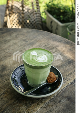Matcha latte with latte art on top Matcha latte with latte art on top 73873352