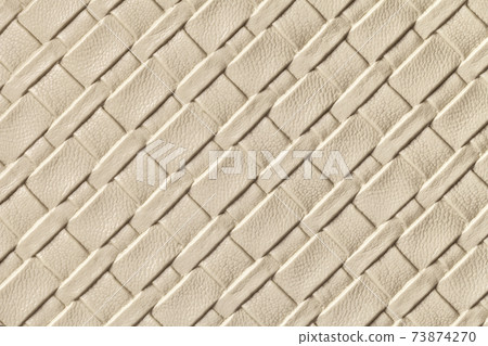 Texture of light beige and sand leather background with wicker pattern, macro. Texture of light beige and sand leather background with wicker pattern, macro. 73874270