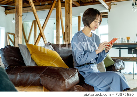 A woman using a computer A woman using a computer 73875680