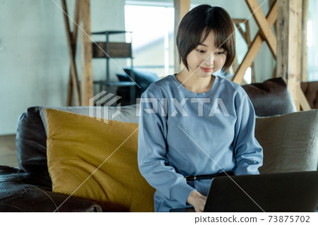 A woman using a computer 73875702