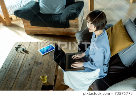 A woman using a computer A woman using a computer 73875773