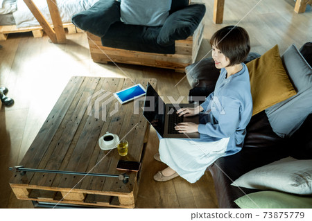 A woman using a computer 73875779