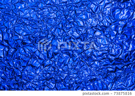 Bright blue foil background with shiny crumpled surface for texture background. Iridescent surface wrinkled foil Bright blue foil background with shiny crumpled surface for texture background. Iridescent surface wrinkled foil 73875816