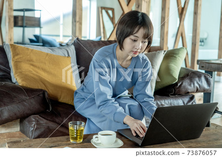 A woman using a computer A woman using a computer 73876057