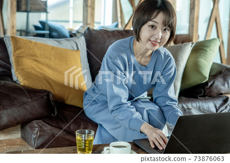 A woman using a computer A woman using a computer 73876063