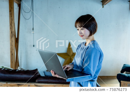 A woman using a computer 73876273