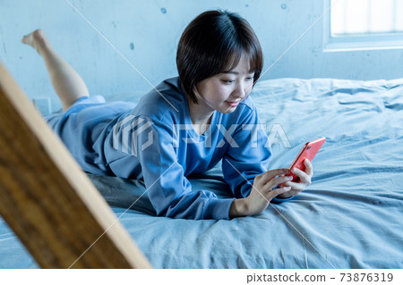 Woman using a smartphone Woman using a smartphone 73876319