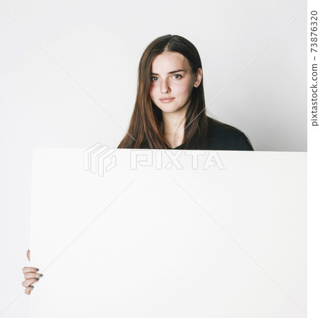 young pretty brunette girl with placard shit copyspace on white background wearing business costume student young pretty brunette girl with placard shit copyspace on white background wearing business costume student 73876320