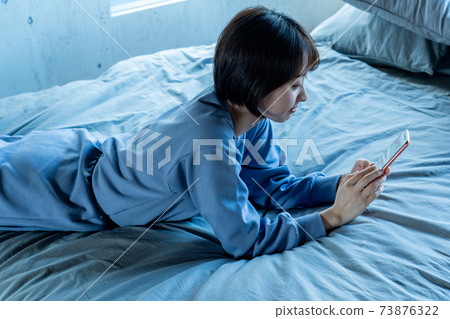 Woman using a smartphone Woman using a smartphone 73876322