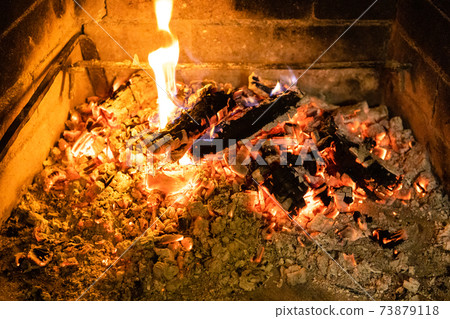 smoldering woods and hot ash in fireplace closeup smoldering woods and hot ash in fireplace closeup 73879118