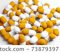 Large number of capsules (medicines, supplements) stock photos 73879397