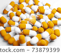 Large amount of capsules (medicines, supplements) and photos of desired light 73879399