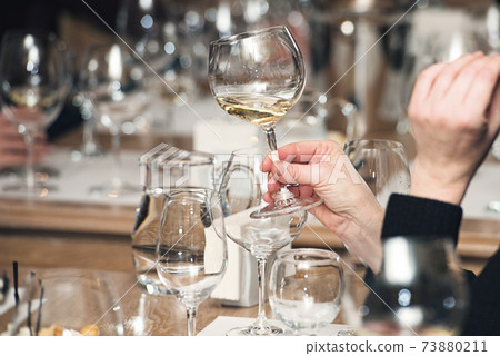 people consider the color of the wine and try how it smells in different glasses 73880211