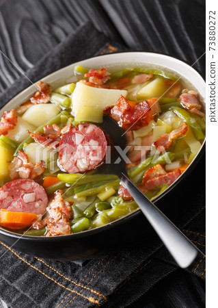 Bouneschlupp Green Bean Soup from Luxembourg close-up in a plate. Vertical Bouneschlupp Green Bean Soup from Luxembourg close-up in a plate. Vertical 73880272