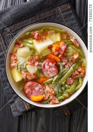 Bouneschlupp Green Bean Soup from Luxembourg close-up in a plate. Vertical top view Bouneschlupp Green Bean Soup from Luxembourg close-up in a plate. Vertical top view 73880278