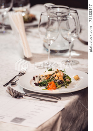 delicious salmon salad with egg in a restaurant. small portion 73880347