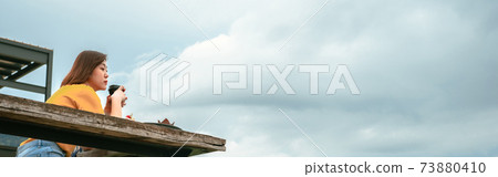 web banner asian woman solo traveler drink coffee with relax at outdoor coffeeshop with mountain background web banner asian woman solo traveler drink coffee with relax at outdoor coffeeshop with mountain background 73880410