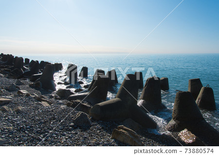 Tetrapod breakwaters on the coast. concrete breakwaters of tetrapods lie all along the coast. 73880574