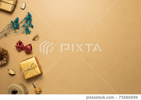 Gift box, dry flower, ribbon, string on brown kraft paper background. flat lay, top view, copy space Gift box, dry flower, ribbon, string on brown kraft paper background. flat lay, top view, copy space 73880899