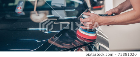 Process of car detailing by hand polisher, polishing the car in the studio, car care concept 73881020