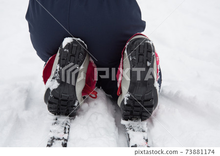 Skier's boots close up. Children's ski boot sole. Child's rest on the ski track 73881174