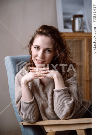 1 european girl with red hair in a beige sweater sitting in a chair, portrait of a woman 1 european girl with red hair in a beige sweater sitting in a chair, portrait of a woman 73881417
