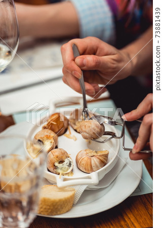 Snails with herbs butter, in traditional ceramic pan bread and s 73881439