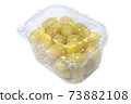 Yellow cherry tomatoes in the plastic container isolated on a white background with a clipping path 73882108
