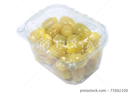 Yellow cherry tomatoes in the plastic container isolated on a white background with a clipping path 73882108