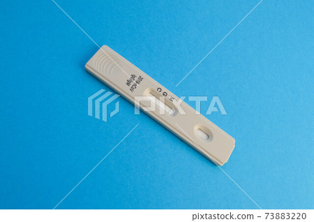 individual set for self-diagnosis of coronavirus. test strip on a blue matte background. kit for testing blood for the determination of IgG and IgM antibodies individual set for self-diagnosis of coronavirus. test strip on a blue matte background. kit for testing blood for the determination of IgG and IgM antibodies 73883220